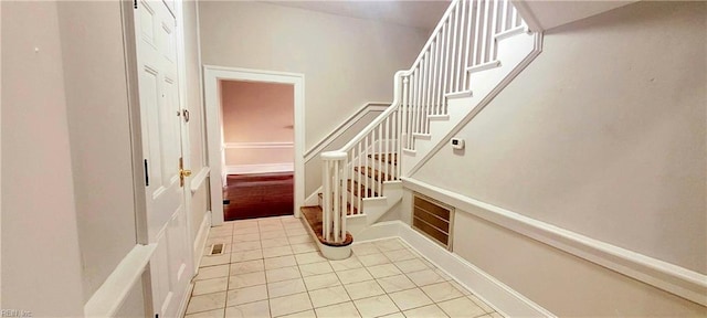 stairway with tile patterned flooring