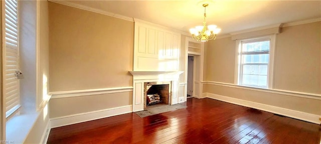 unfurnished living room with ornamental molding, dark hardwood / wood-style floors, and a chandelier