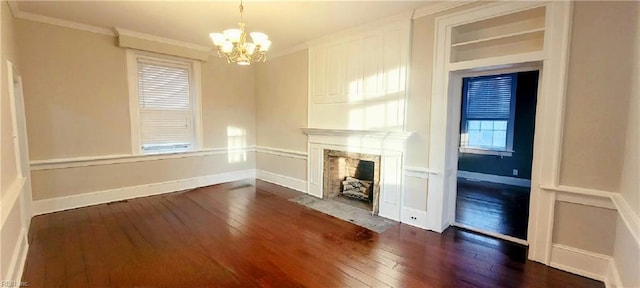 unfurnished living room featuring a chandelier, ornamental molding, a fireplace, and dark hardwood / wood-style flooring