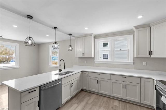 kitchen featuring sink, decorative light fixtures, kitchen peninsula, dishwasher, and light hardwood / wood-style floors