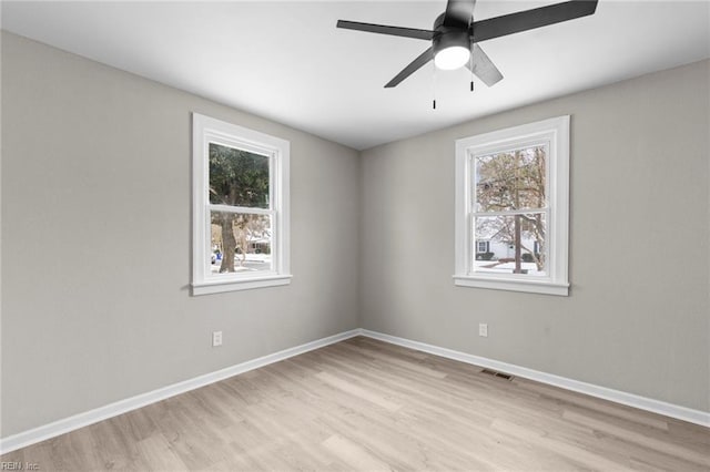 unfurnished room with ceiling fan, plenty of natural light, and light wood-type flooring