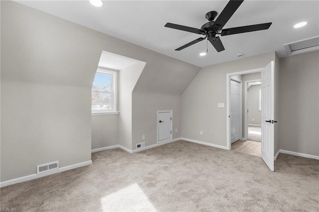 bonus room featuring vaulted ceiling, light carpet, and ceiling fan