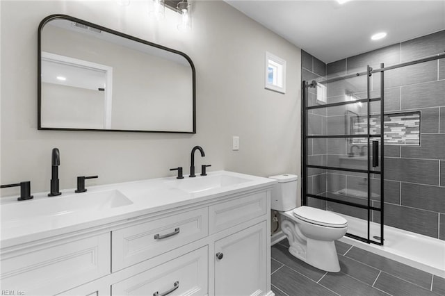 bathroom featuring vanity, toilet, and a tile shower