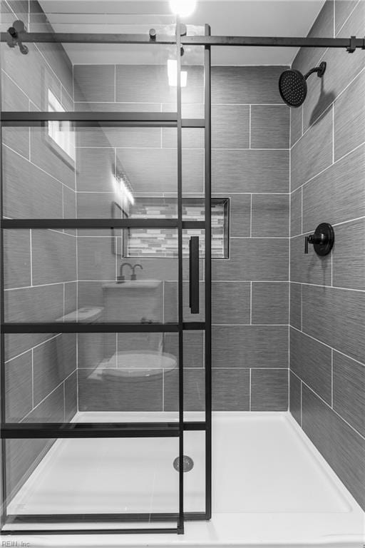 bathroom featuring a shower with door