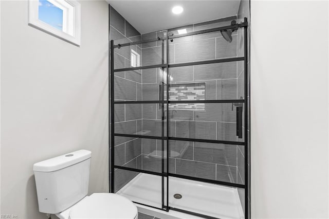 bathroom with walk in shower and toilet