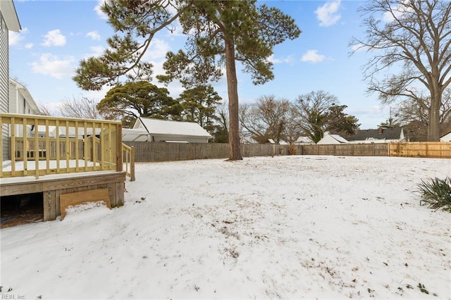 snowy yard featuring a deck