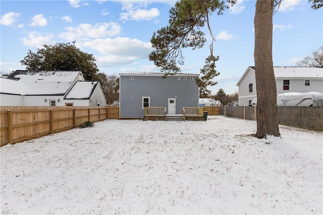 snow covered property with a wooden deck