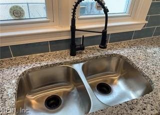 room details with light stone counters and sink