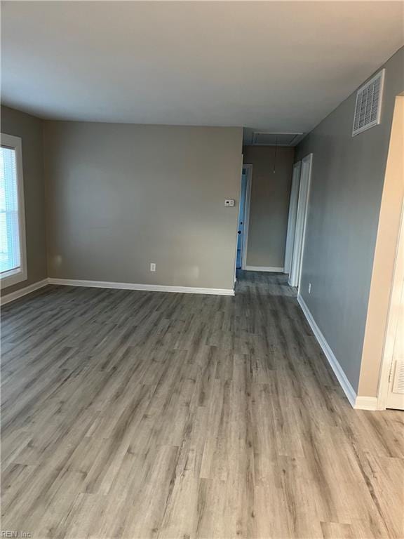 unfurnished room featuring hardwood / wood-style flooring