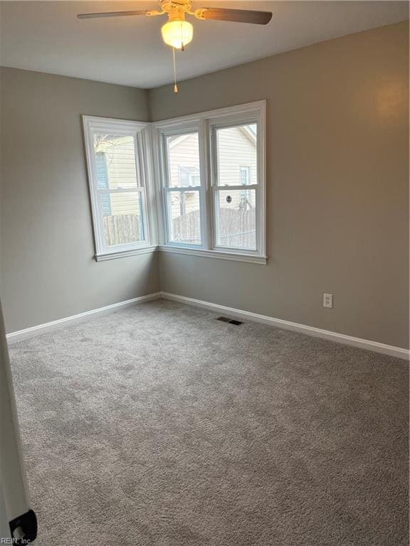 carpeted empty room with ceiling fan