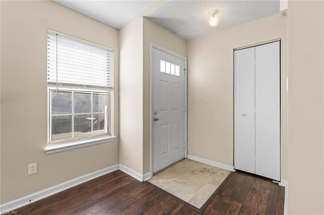 entrance foyer featuring dark hardwood / wood-style floors and a textured ceiling