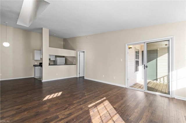 unfurnished living room with lofted ceiling and dark hardwood / wood-style flooring