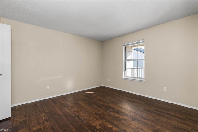 empty room featuring dark wood-type flooring