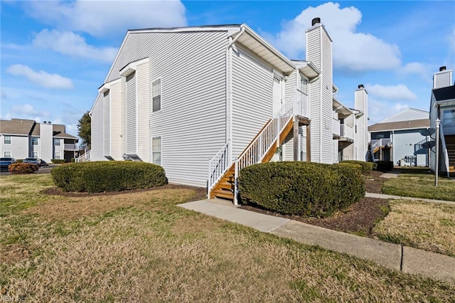 view of property exterior with a yard