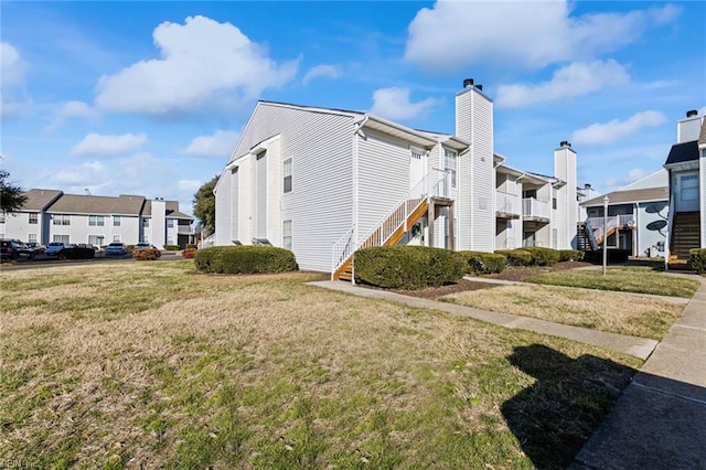 view of side of home with a yard