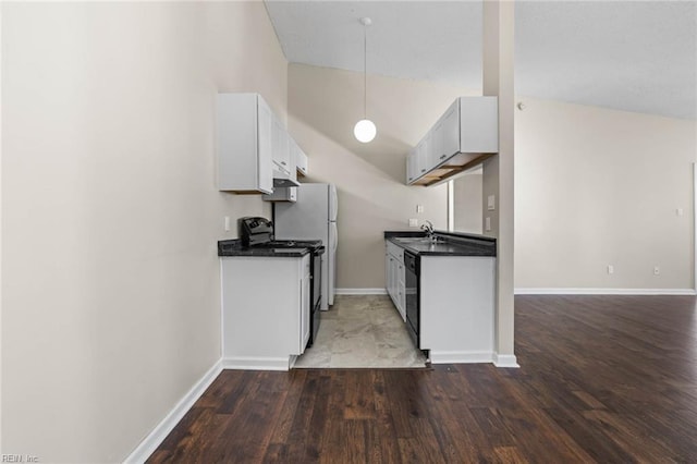 kitchen featuring lofted ceiling, sink, black appliances, and dark hardwood / wood-style floors