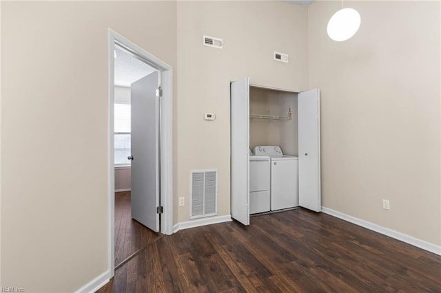 hall featuring washer and dryer and dark hardwood / wood-style floors