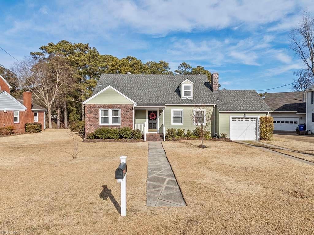 cape cod house with a porch, a garage, and a front yard