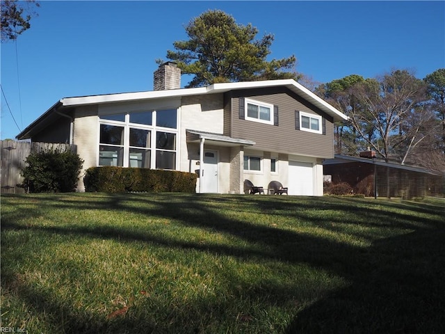 rear view of property featuring a lawn