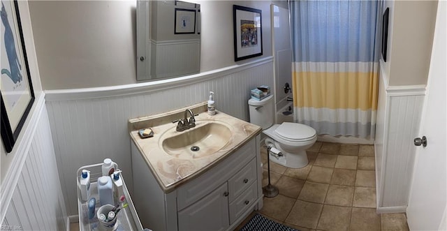 bathroom featuring tile patterned flooring, vanity, and toilet