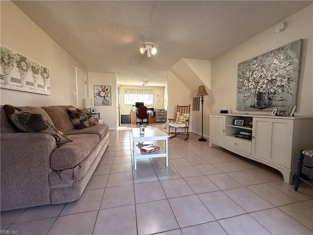 tiled living room featuring a textured ceiling