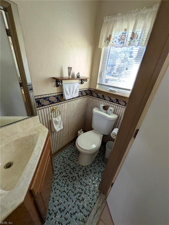 bathroom with vanity, tile patterned flooring, and toilet