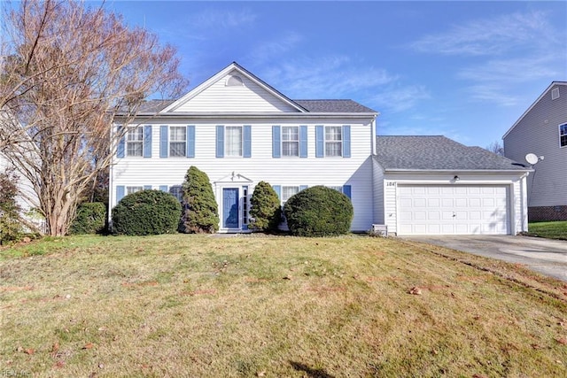 view of front facade with a garage and a front lawn