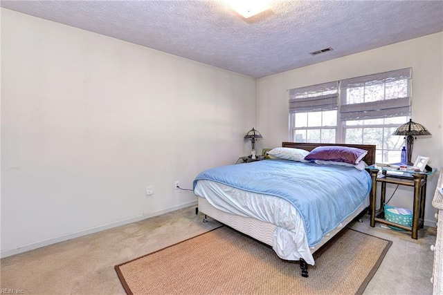 bedroom featuring carpet flooring and a textured ceiling