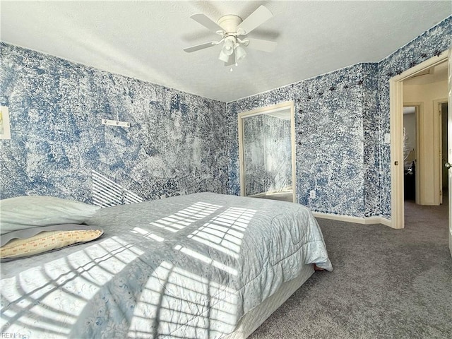 carpeted bedroom featuring ceiling fan and a textured ceiling