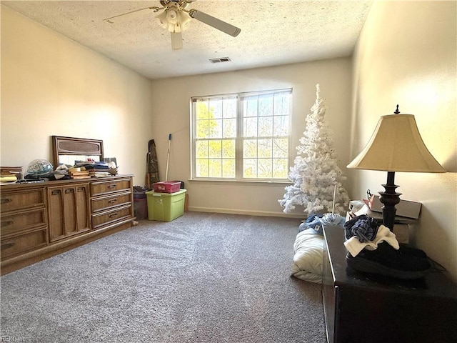 interior space with ceiling fan and a textured ceiling