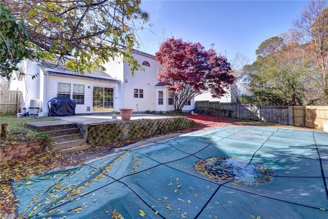 view of swimming pool with grilling area and a patio