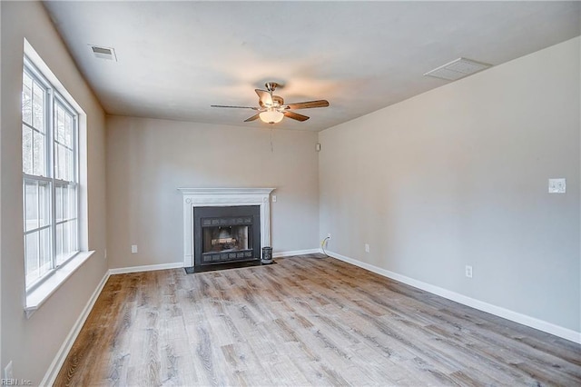 unfurnished living room with ceiling fan and light hardwood / wood-style floors