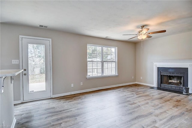 unfurnished living room with ceiling fan and light wood-type flooring