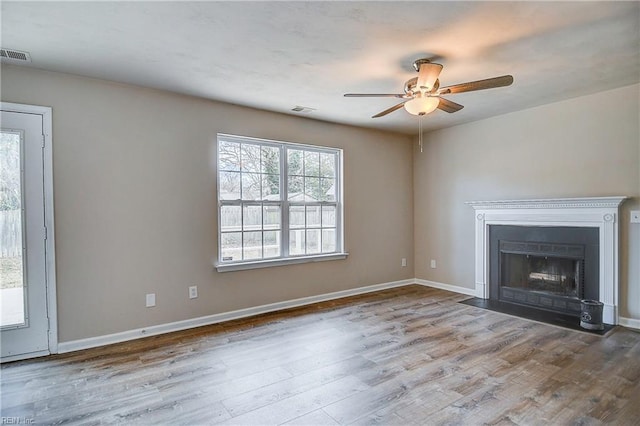 unfurnished living room with hardwood / wood-style flooring and ceiling fan