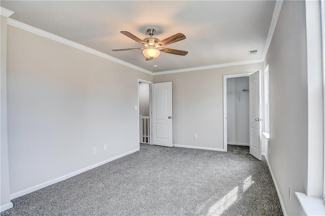 unfurnished bedroom featuring ceiling fan, a closet, ornamental molding, and carpet