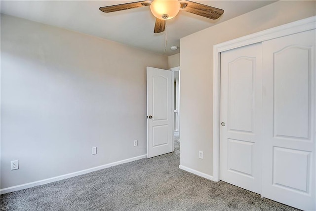 unfurnished bedroom featuring light carpet, ceiling fan, and a closet