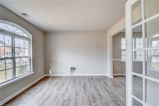 spare room with light hardwood / wood-style flooring