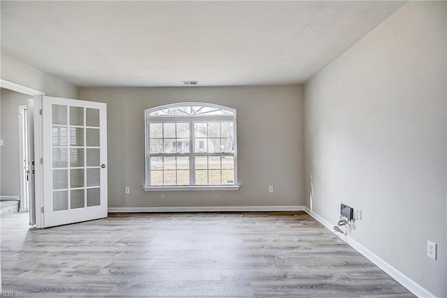 spare room with light hardwood / wood-style floors