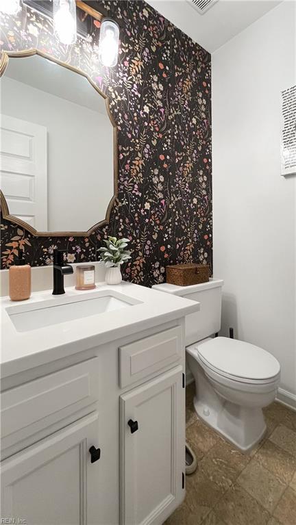 bathroom featuring vanity and toilet