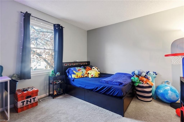 bedroom featuring carpet flooring and a textured ceiling