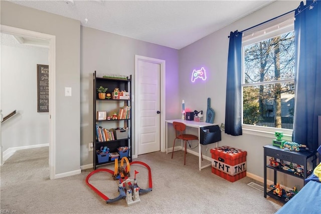 recreation room with carpet floors and a healthy amount of sunlight