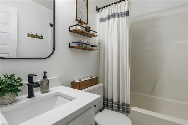 full bathroom with vanity, shower / tub combo with curtain, and toilet