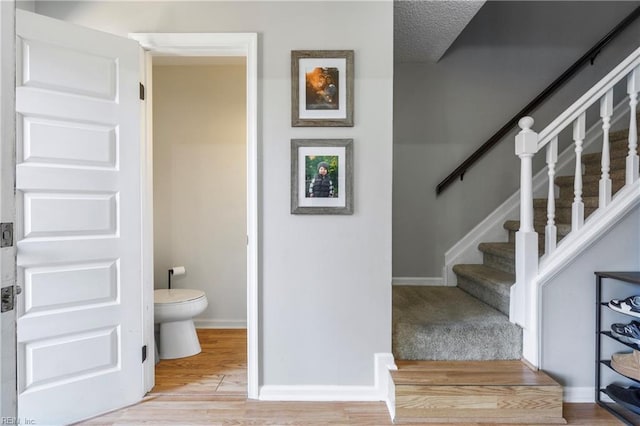 stairs with hardwood / wood-style floors