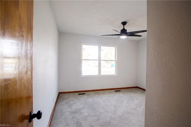 carpeted empty room with ceiling fan