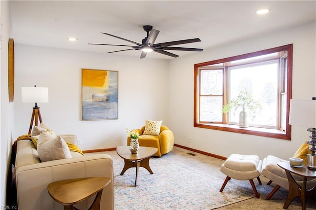 sitting room featuring carpet and ceiling fan