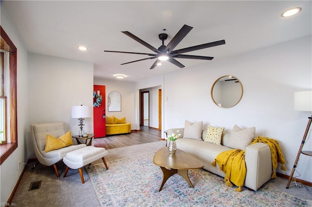 living room with ceiling fan and carpet flooring