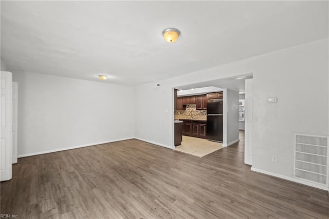 unfurnished living room featuring hardwood / wood-style flooring