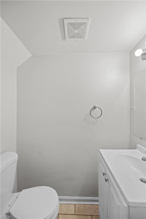 bathroom featuring tile patterned floors, toilet, and vanity