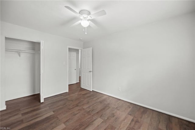 unfurnished bedroom with ceiling fan, dark hardwood / wood-style flooring, and a closet