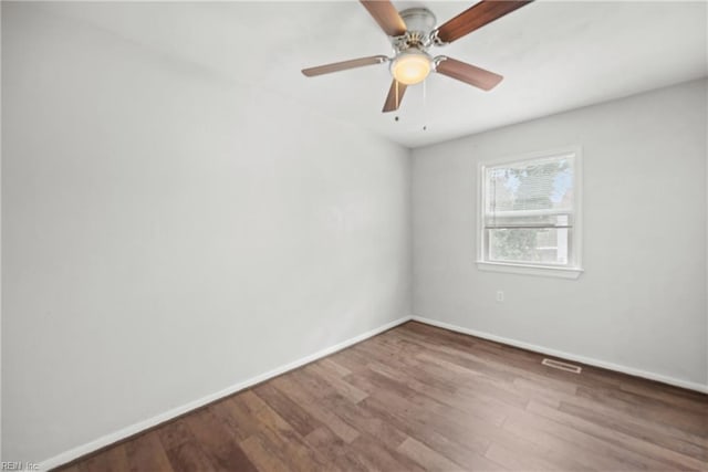 spare room with ceiling fan and hardwood / wood-style floors